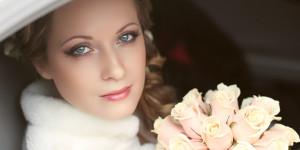 Beautiful bride woman portrait with bridal bouquet posing in her wedding day Mahogany